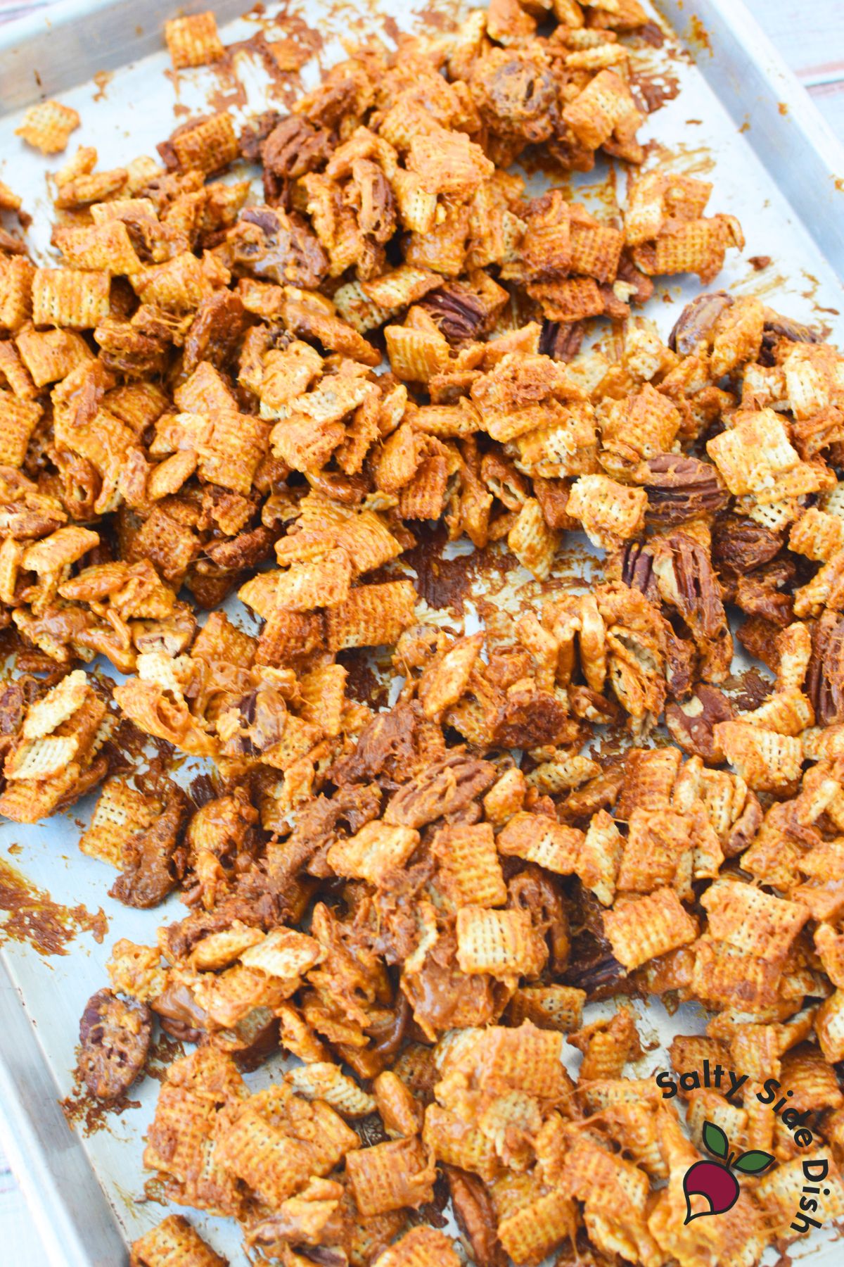 Caramel pecan clusters flipped onto a second baking sheet to cool and set