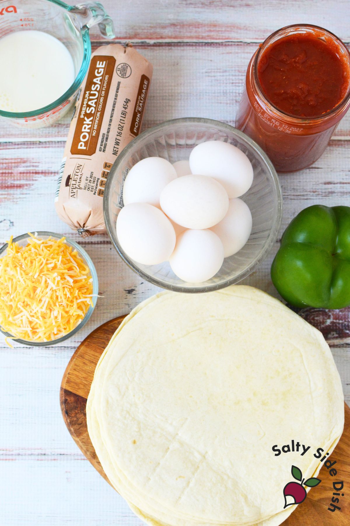 Ingredients for slow cooker breakfast tacos including eggs, sausage, salsa, cheese, and tortillas