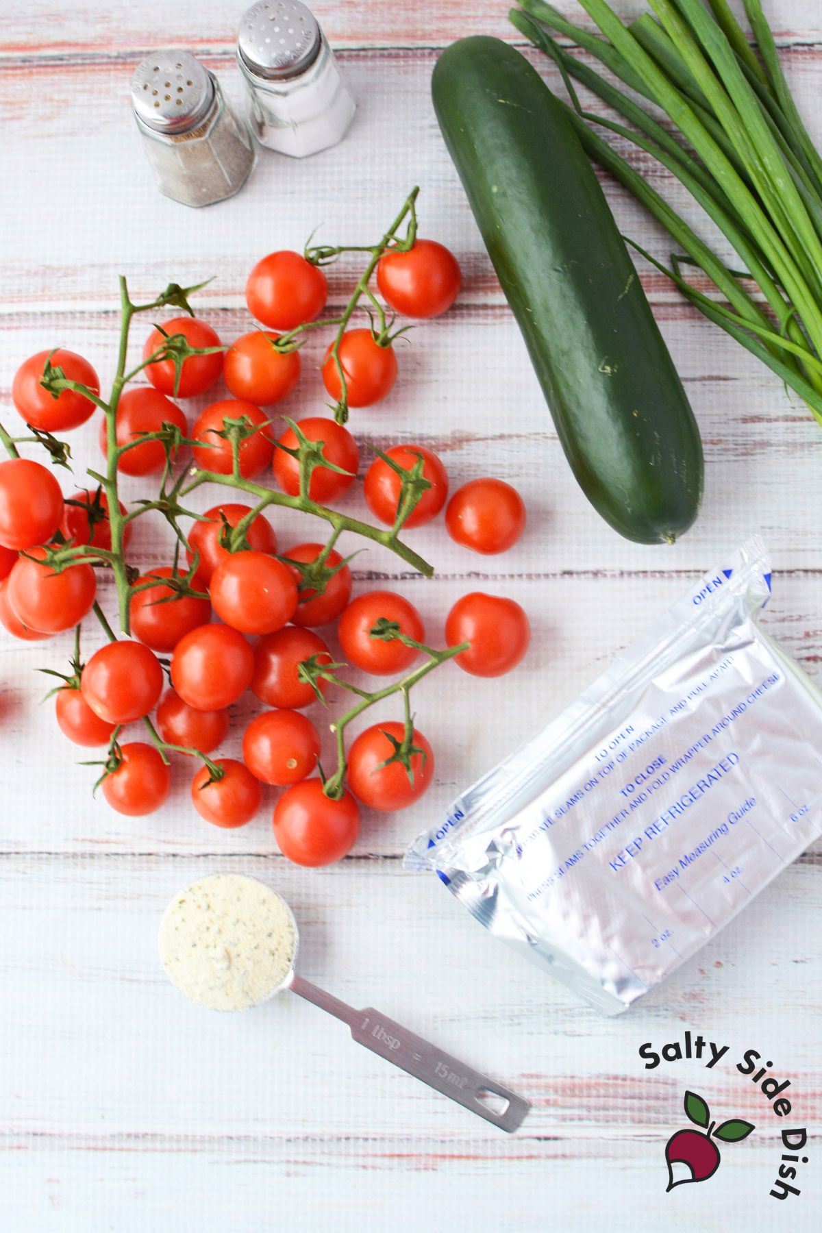 Ingredients for tulip tomatoes including cherry tomatoes cream cheese cucumber ranch seasoning and green onions