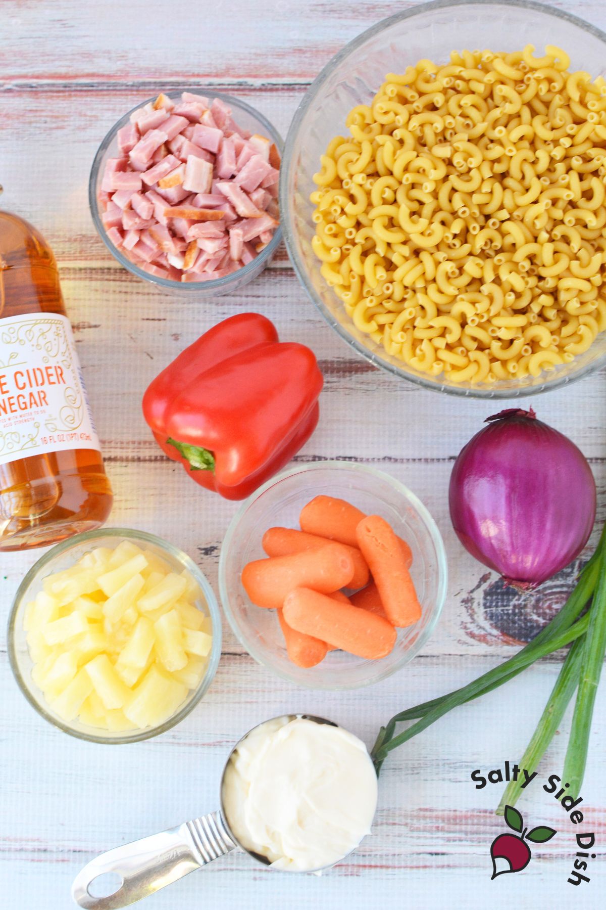Ingredients for Hawaiian pasta salad including cooked elbow pasta ham pineapple mayonnaise vinegar vegetables