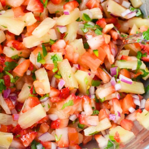 Strawberry pineapple salsa mixed together in a bowl