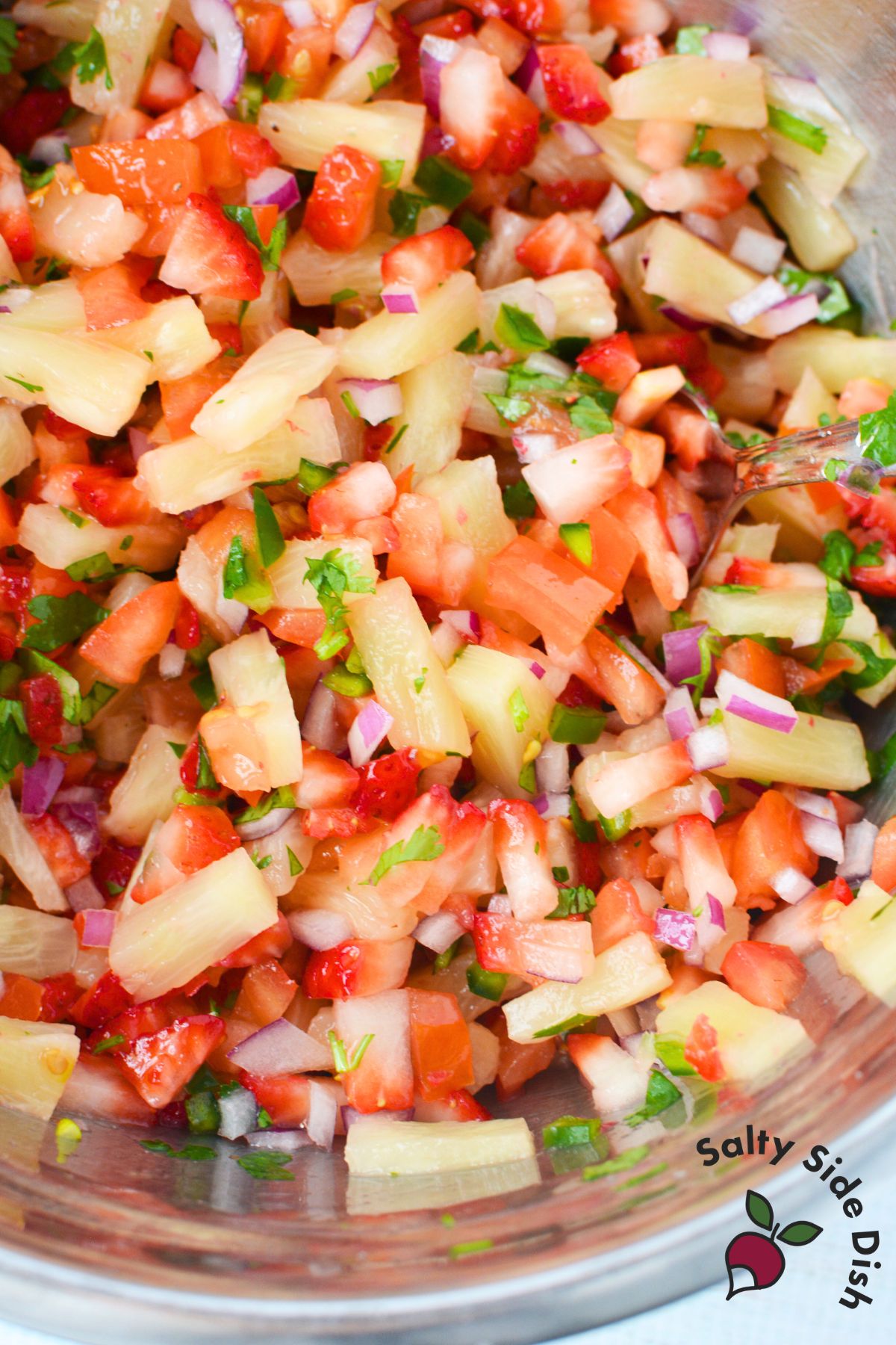 Strawberry pineapple salsa mixed together in a bowl