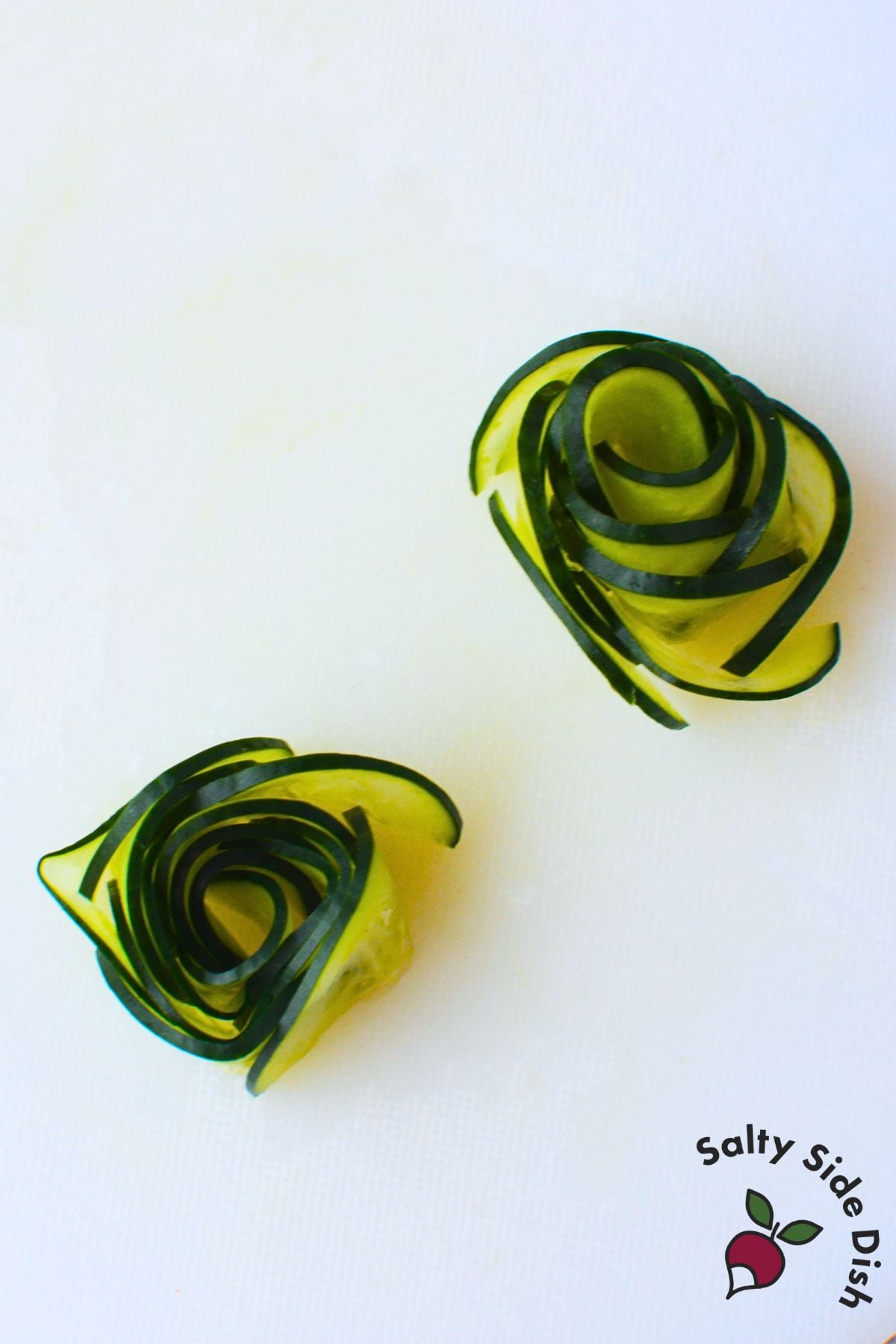 Finished cucumber rose garnish made with thinly sliced cucumber