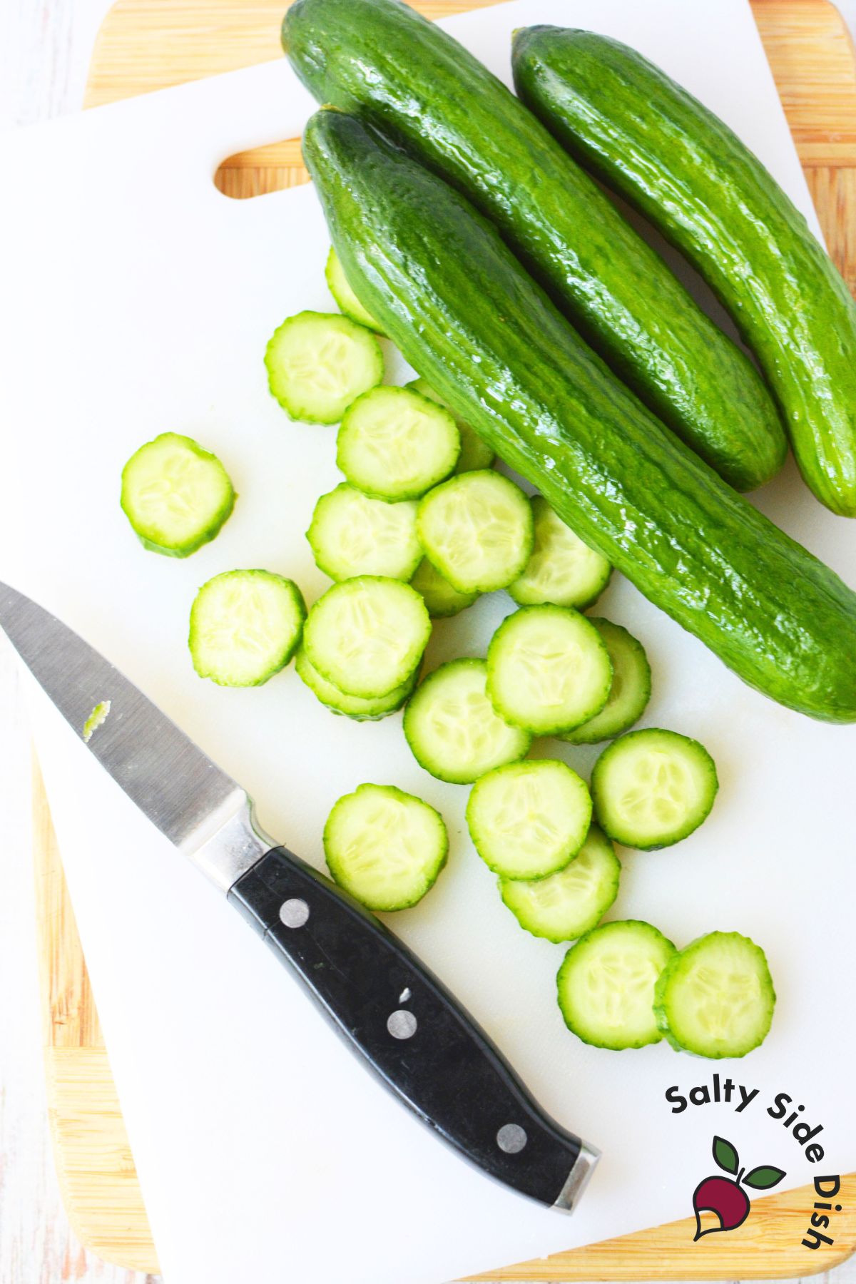 Slicing mini cucumbers into thin rounds for balsamic cucumber salad