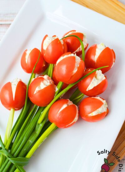 Finished tulip tomatoes filled with cream cheese and cucumber served as a simple spring appetizer