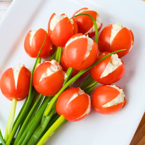 Finished tulip tomatoes filled with cream cheese and cucumber served as a simple spring appetizer