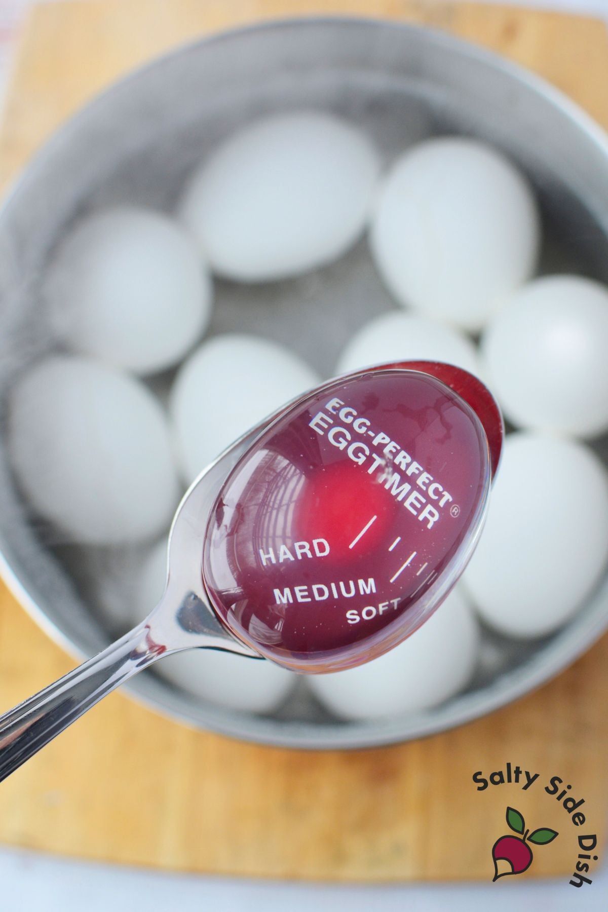 egg timer in pot of boiling eggs showing hard boiled stage for deviled eggs