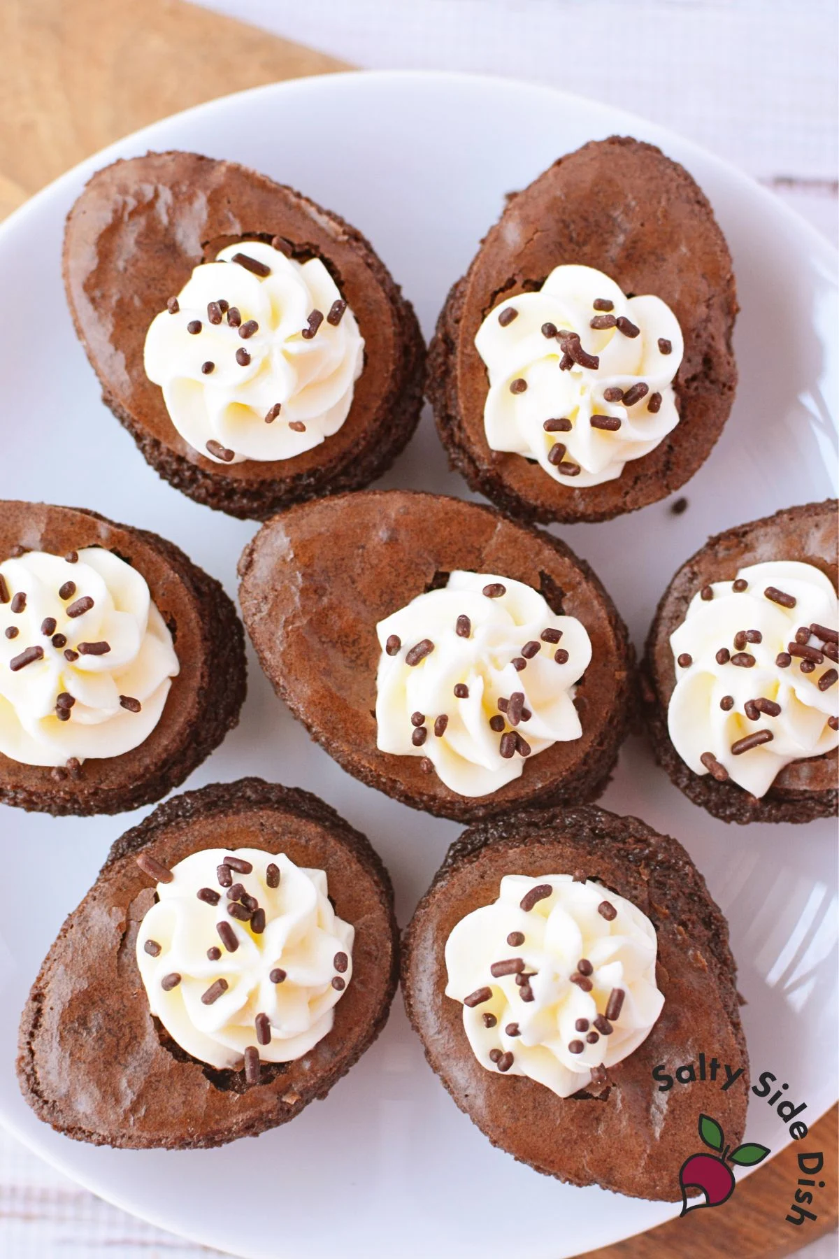 Easter deviled brownies arranged on a plate with cream cheese filling and chocolate sprinkles