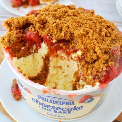 Philadelphia no bake cheesecake layered with cherry pie filling and crushed Biscoff cookies in original container