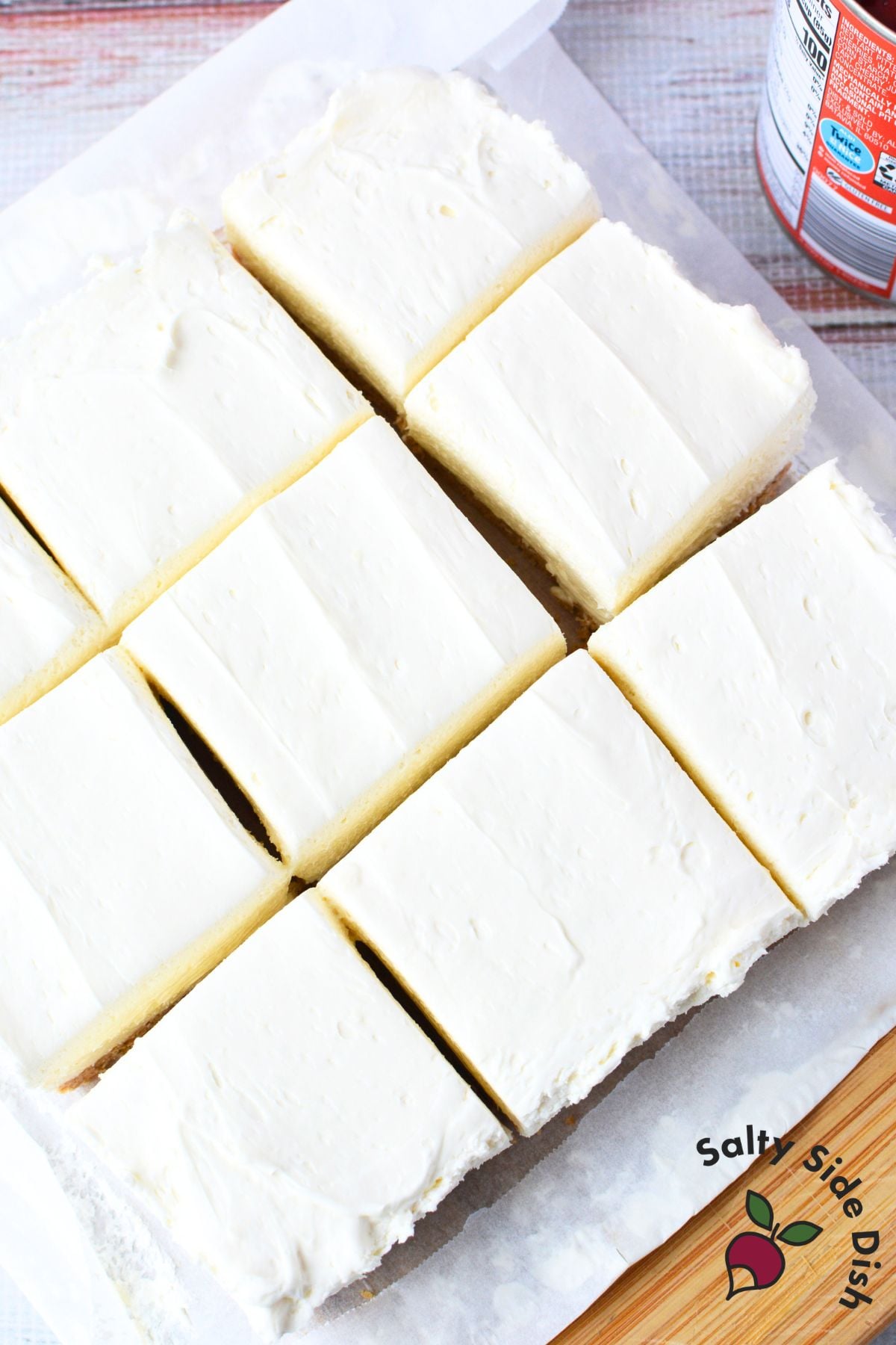 no bake cherry cheesecake bars cut into squares on parchment paper