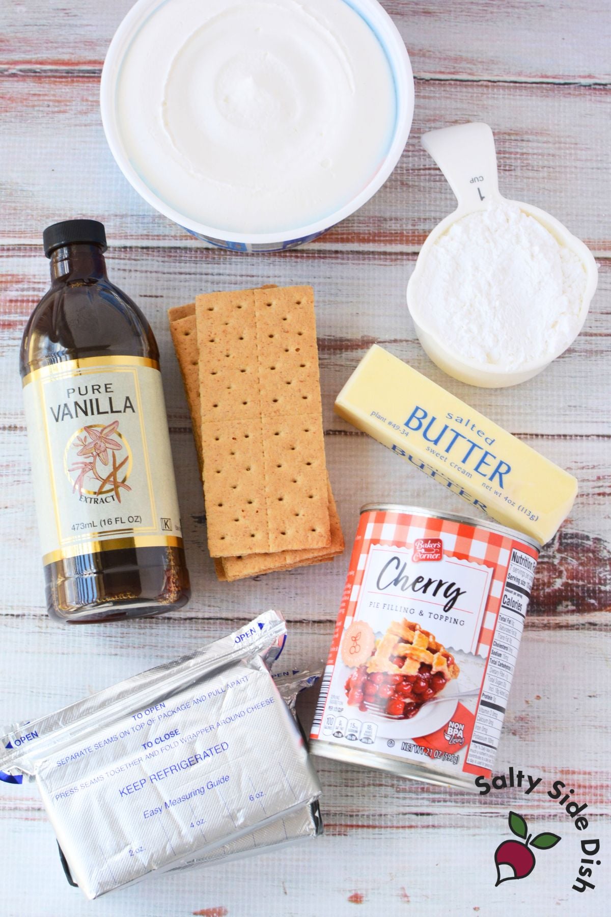 ingredients for no bake cherry cheesecake bars including cream cheese cool whip graham crackers butter vanilla and cherry pie filling