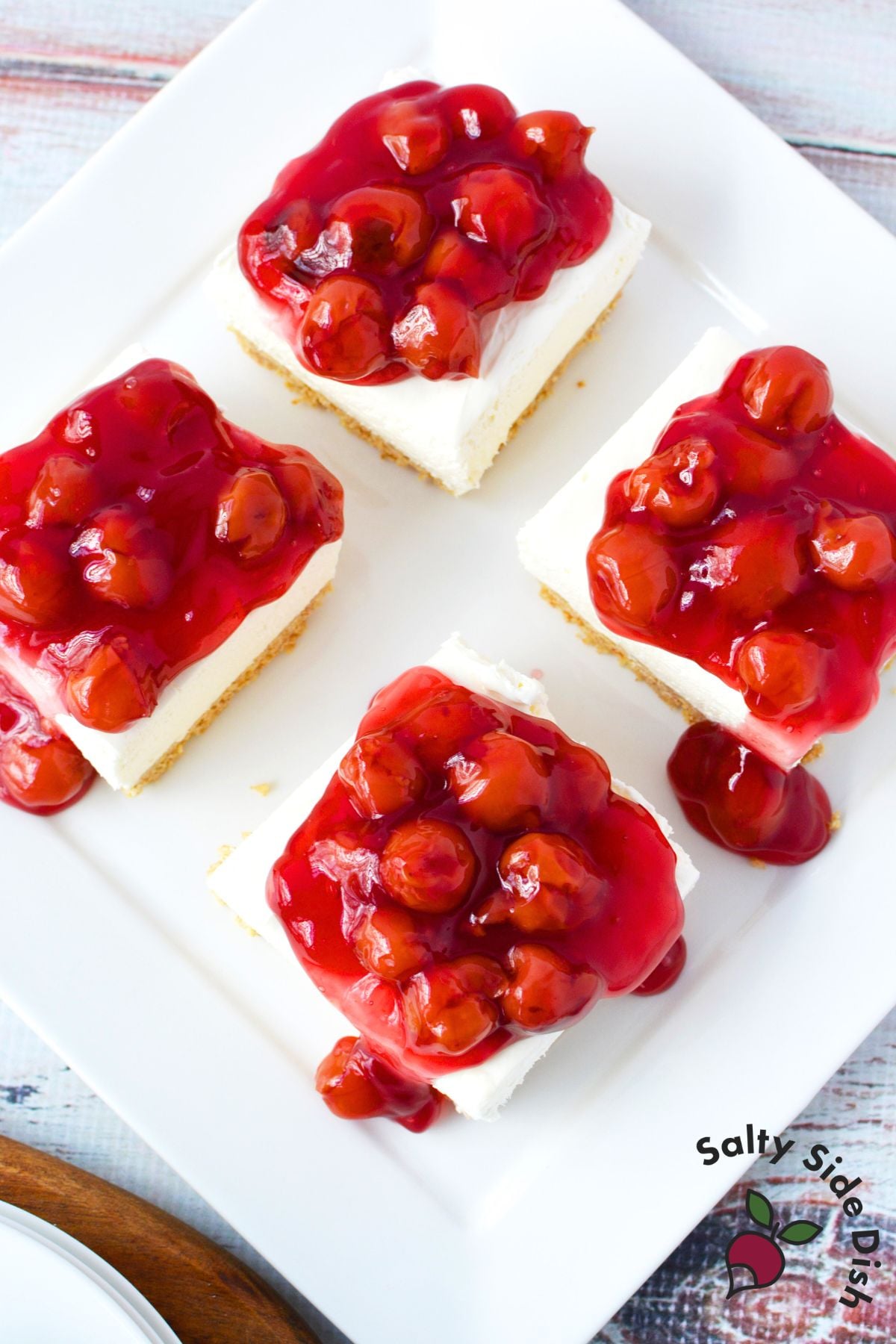 4 cheesecake bars with cherry pie filling.