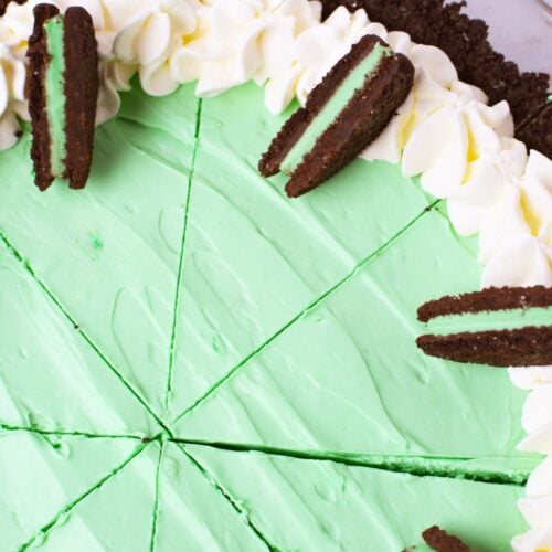 top view of grasshopper pie sliced with whipped cream and oreo garnish