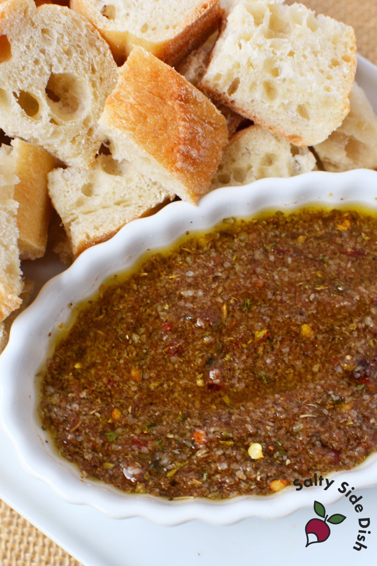 Easy bread dip recipe with olive oil, balsamic vinegar, parmesan cheese, and crusty bread cubes