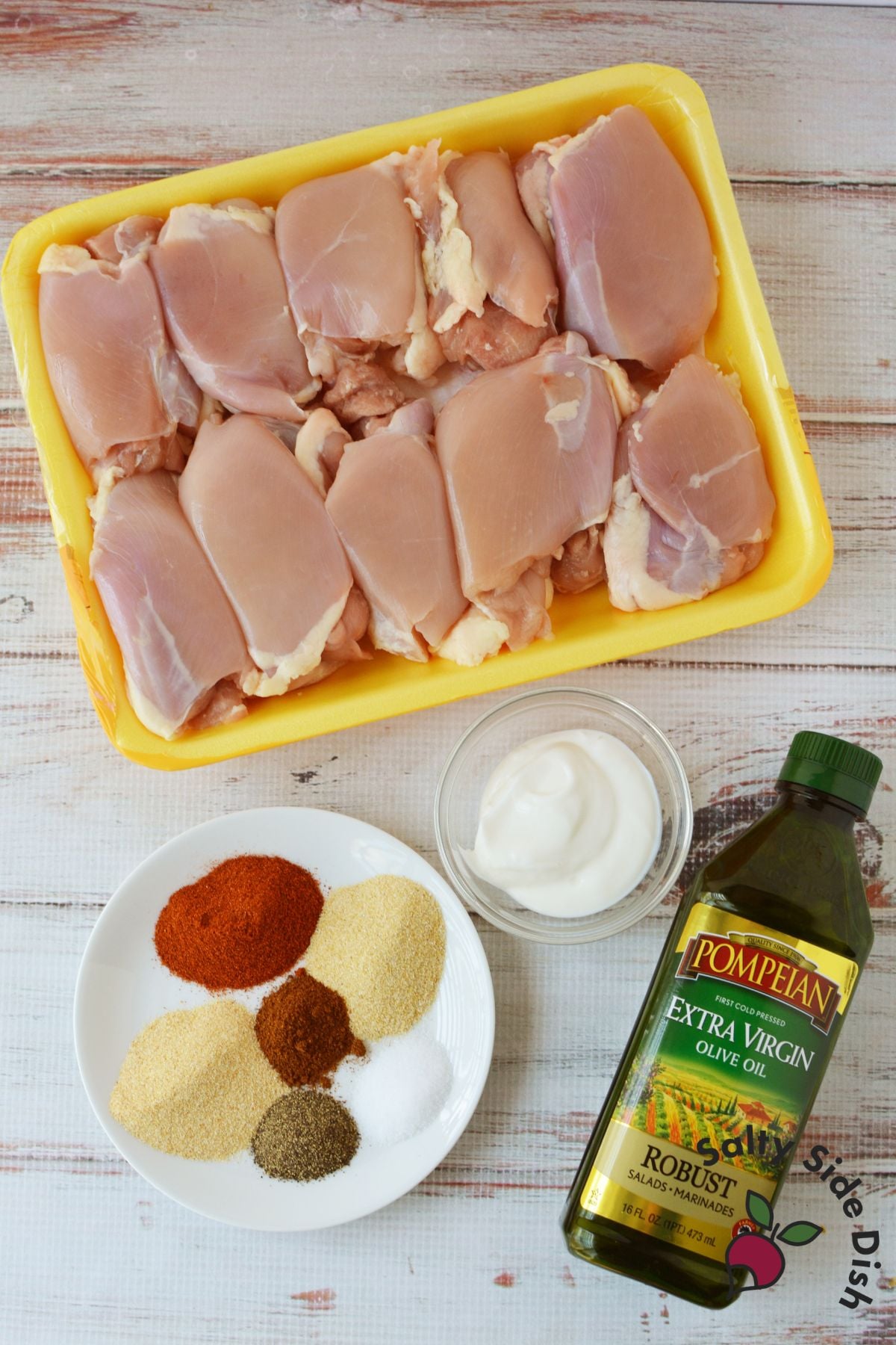 Ingredients for batch-cooked chicken thighs including spices, olive oil, and Greek yogurt