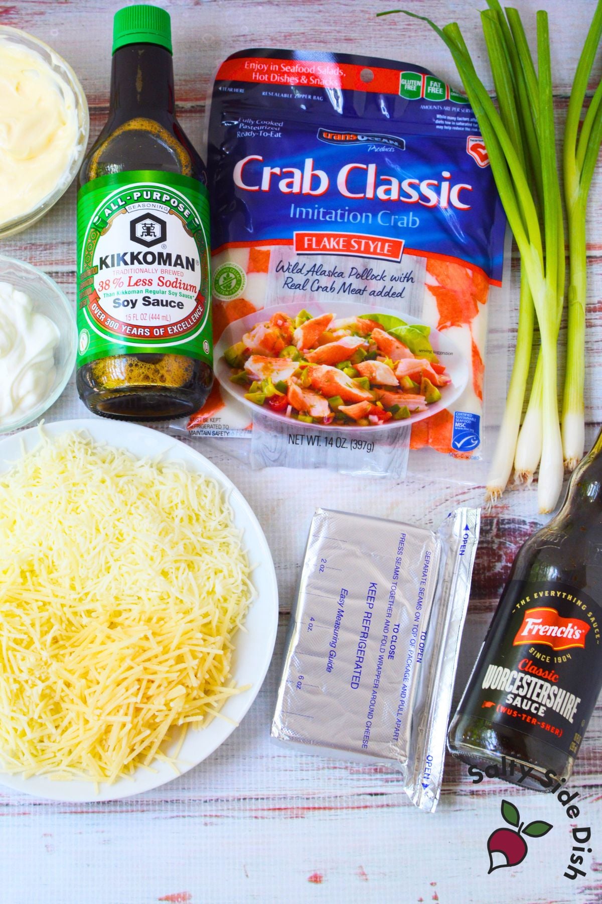 Imitation crab, soy sauce, Worcestershire, cheese, and green onions on a counter