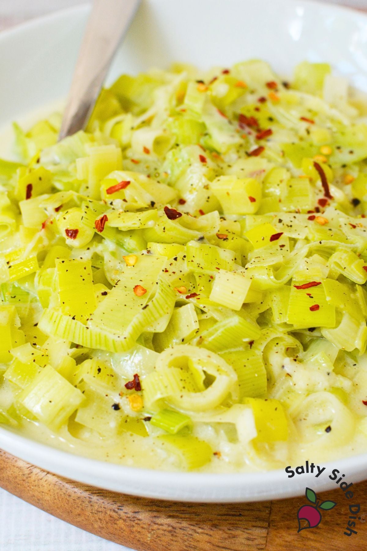 Close up of creamy leeks with parmesan sauce and red pepper flakes