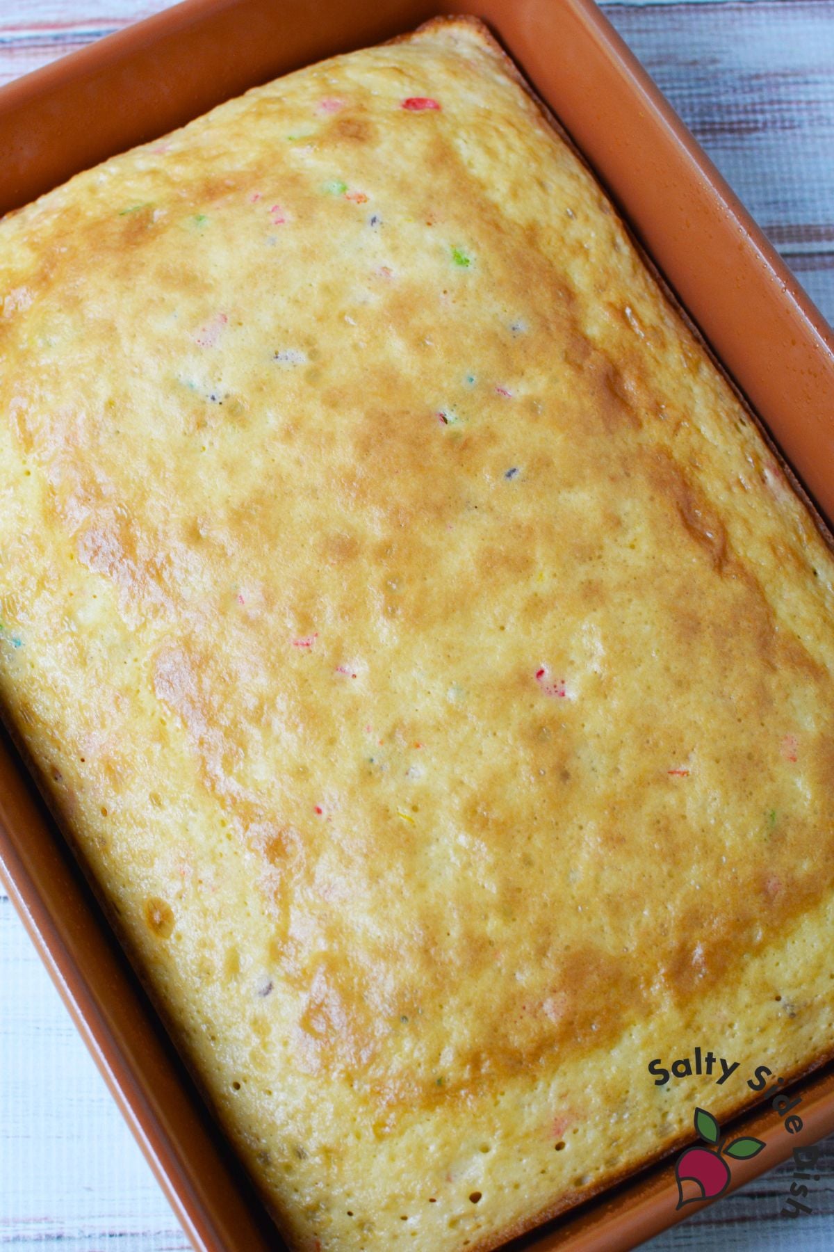 Baked fruity pebbles cake in a rectangular baking pan