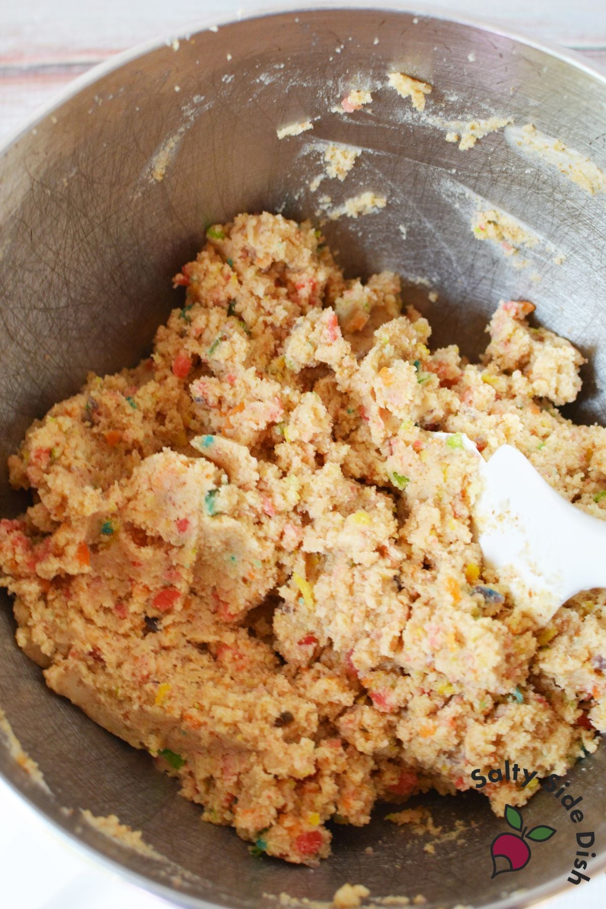 Fruity pebbles cake batter mixed in a stainless steel bowl