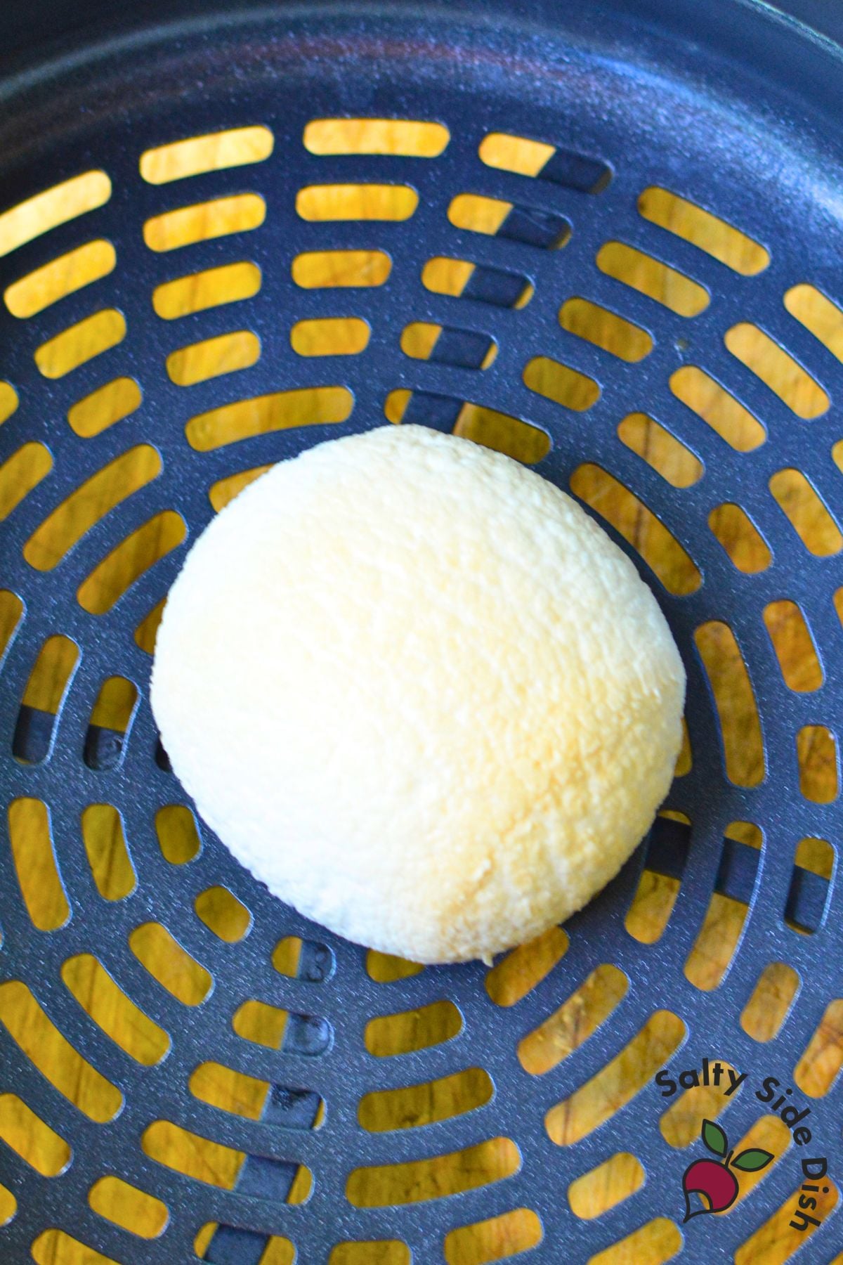 Toasted marshmallow in an air fryer basket after cooking