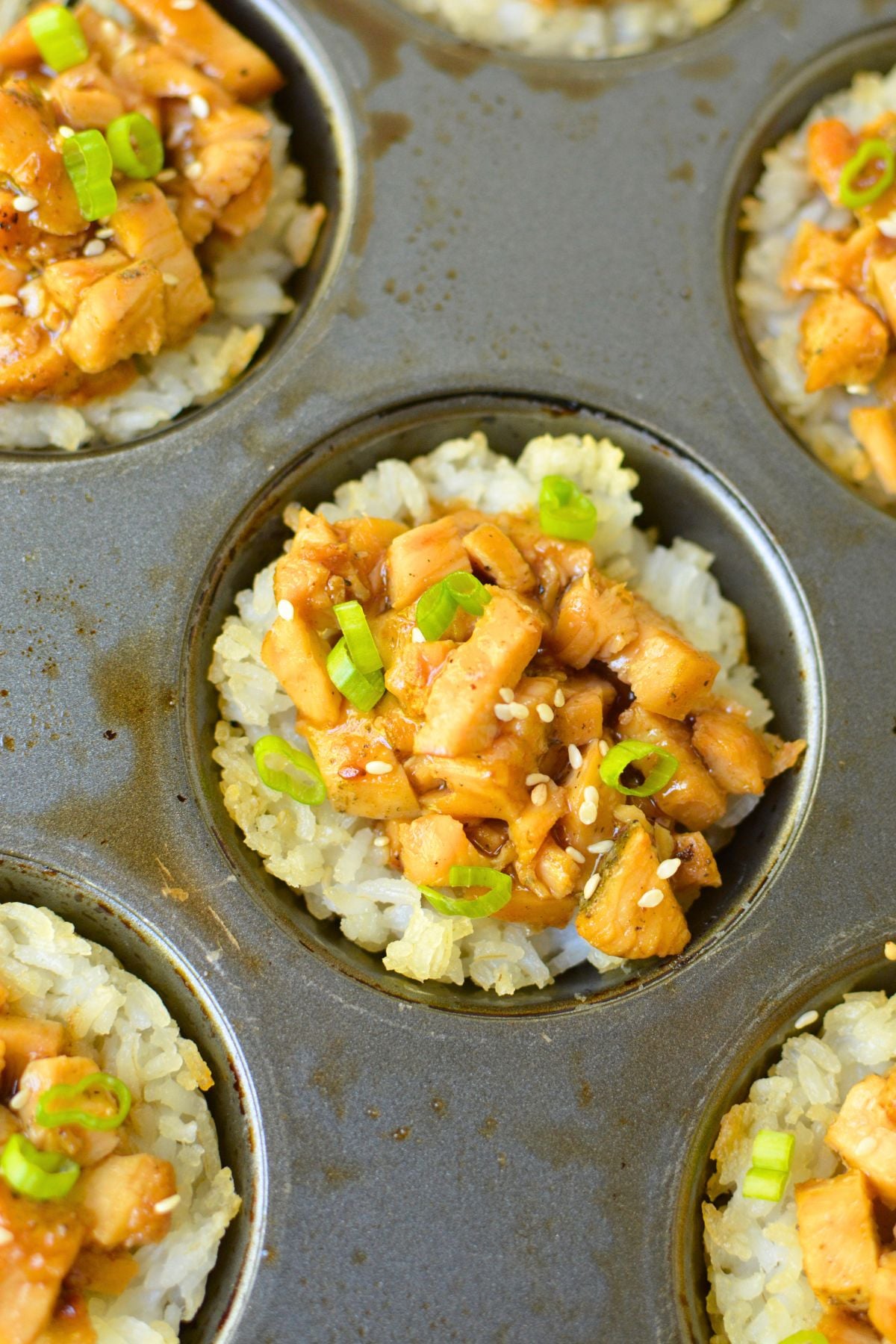 Chicken teriyaki rice cups baked in a metal muffin pan