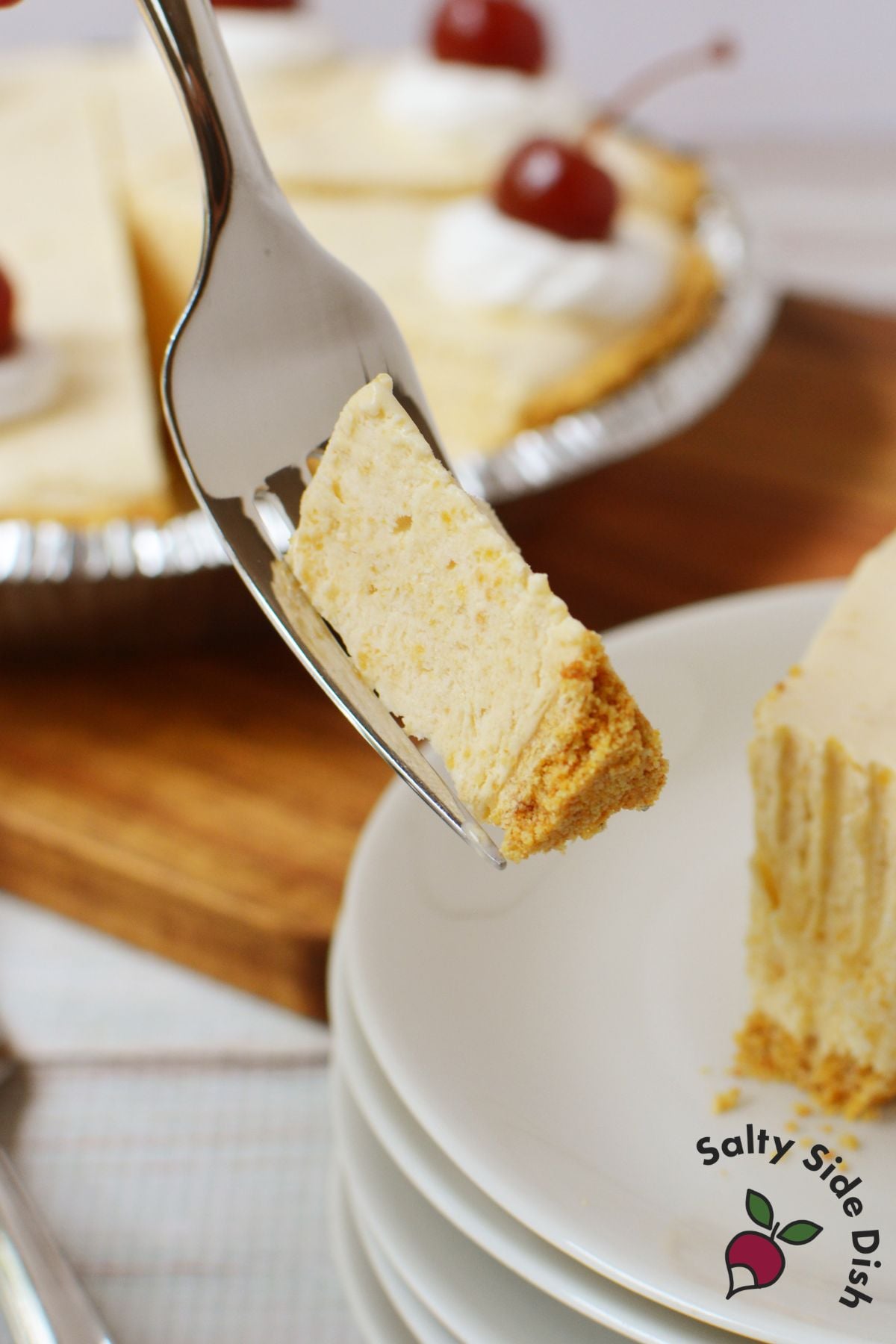 Fork holding a bite of root beer float pie on a plate