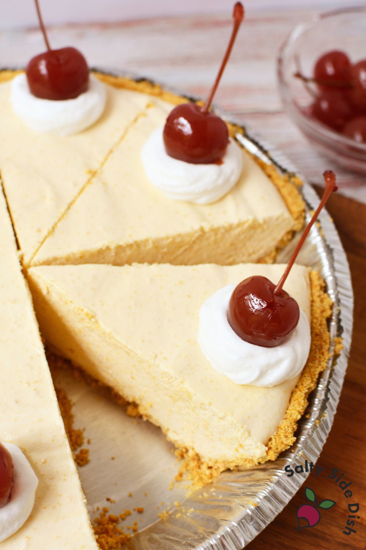 Root beer float pie topped with whipped cream and maraschino cherries