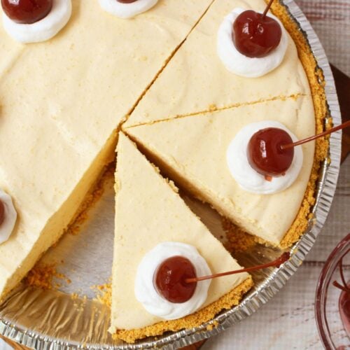 Overhead view of root beer float pie sliced and topped with cherries