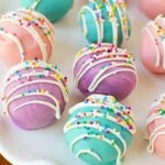 Pastel Spring Oreo Truffles with colorful candy coating, white drizzle, and rainbow sprinkles ready to serve.
