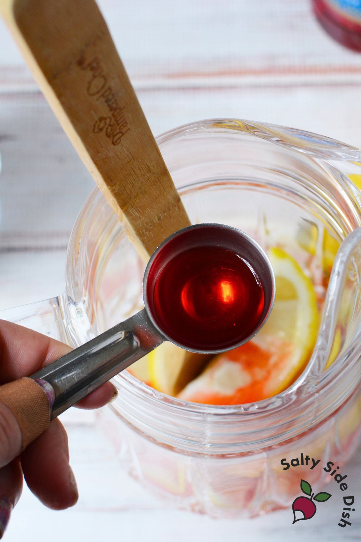 Strawberry syrup, lemons, sugar, and ice for a lemonade shake up