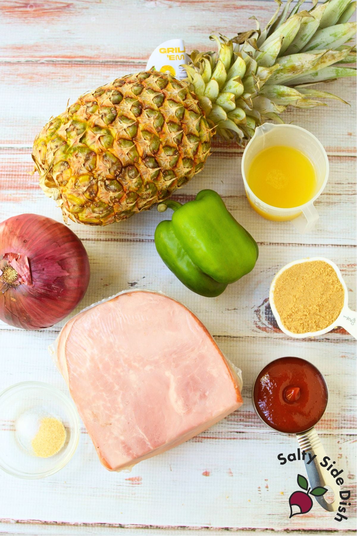 Ingredients for grilled ham pineapple kabobs including ham, fresh pineapple, bell pepper, red onion and pineapple juice