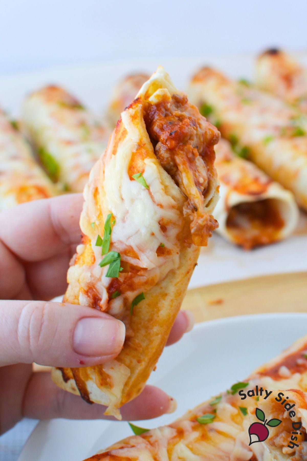 Lasagna roll with tortilla filled with Italian sausage, pasta sauce, cottage cheese, and melted mozzarella