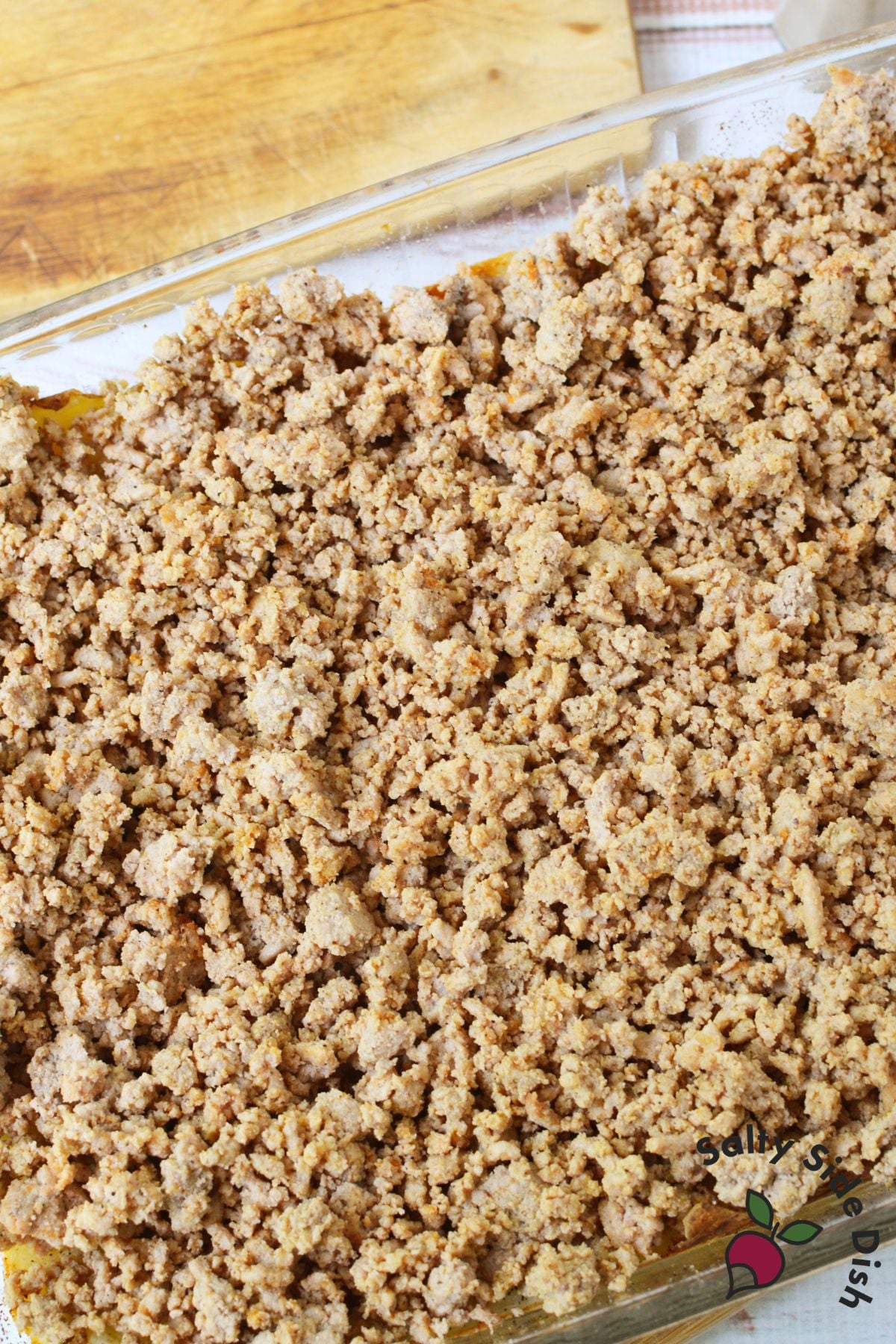 Cooked seasoned ground turkey spread evenly over baked potato crust