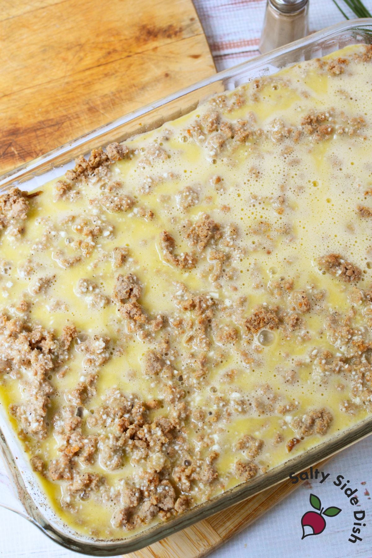 Egg and cottage cheese mixture poured over ground turkey layer in baking dish