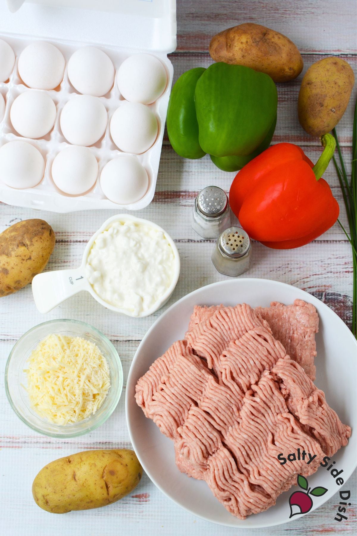 Ingredients for breakfast potato casserole including eggs, potatoes, ground turkey, bell peppers and cottage cheese