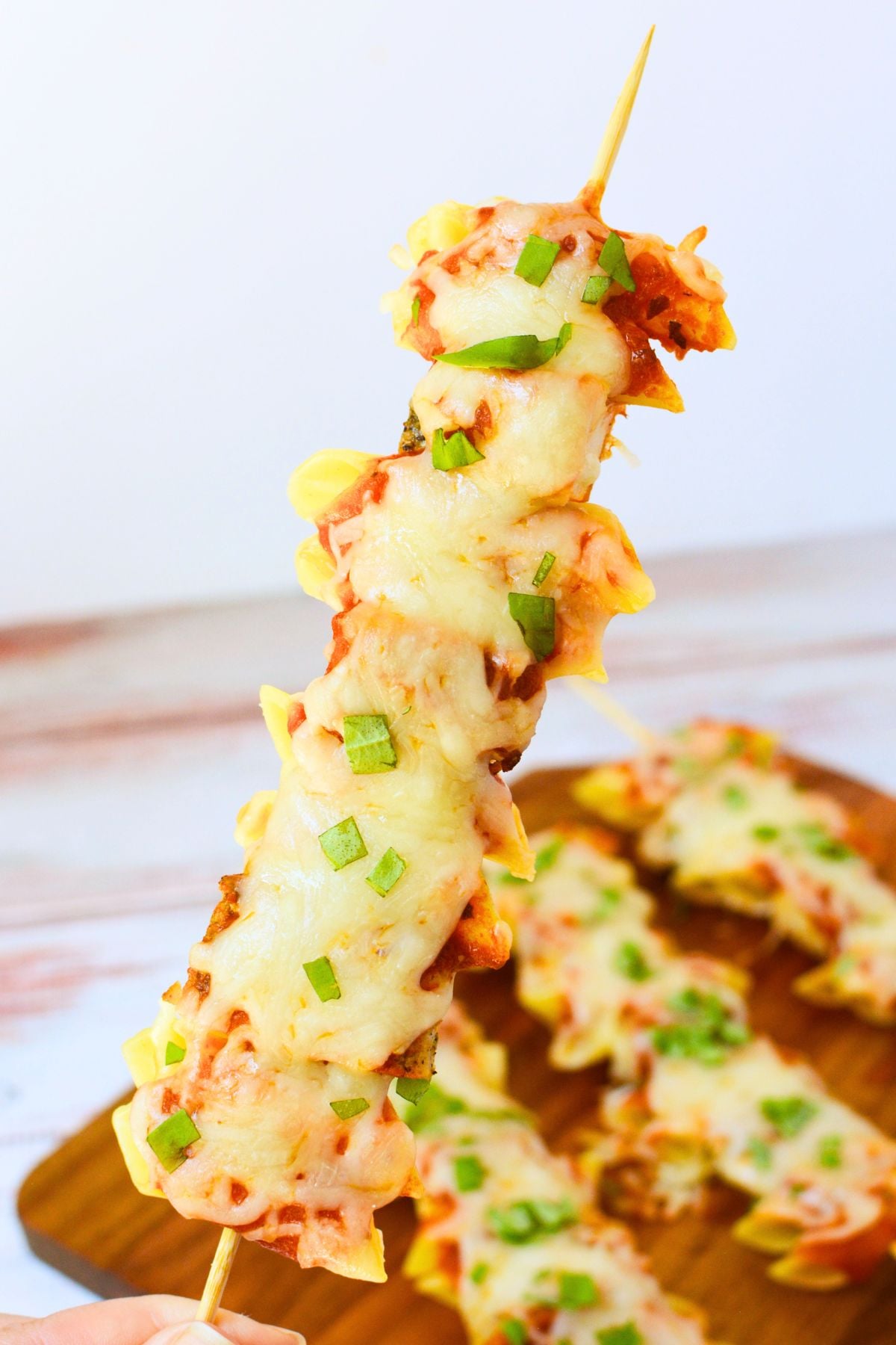 Chicken Parmesan pasta skewers with marinara, melted mozzarella, and fresh basil