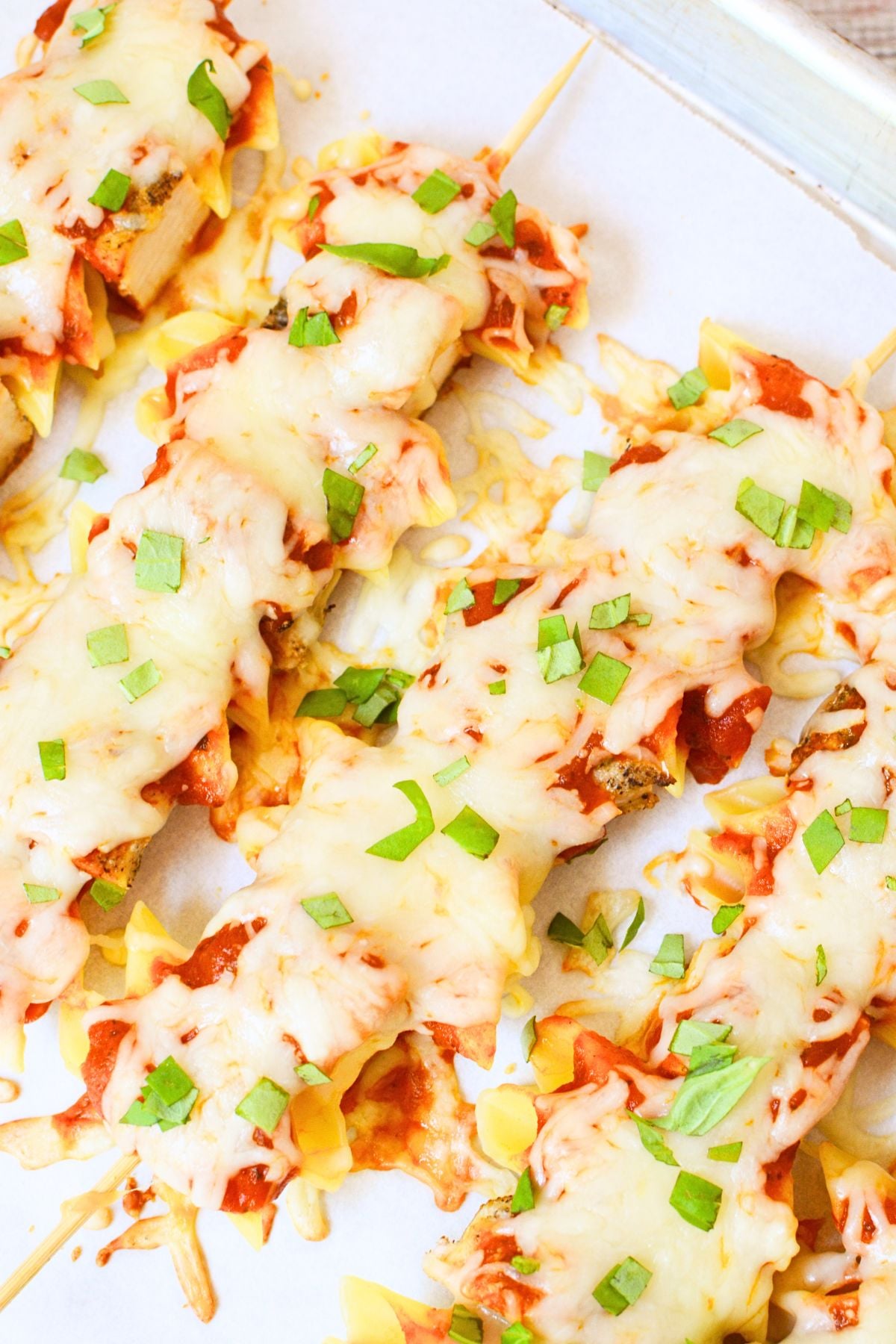Chicken Parmesan pasta skewer with chicken, penne, marinara, mozzarella, and basil