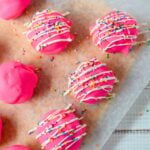 Pink Circus Animal Cookie Truffles drizzled with white candy melts and topped with rainbow sprinkles