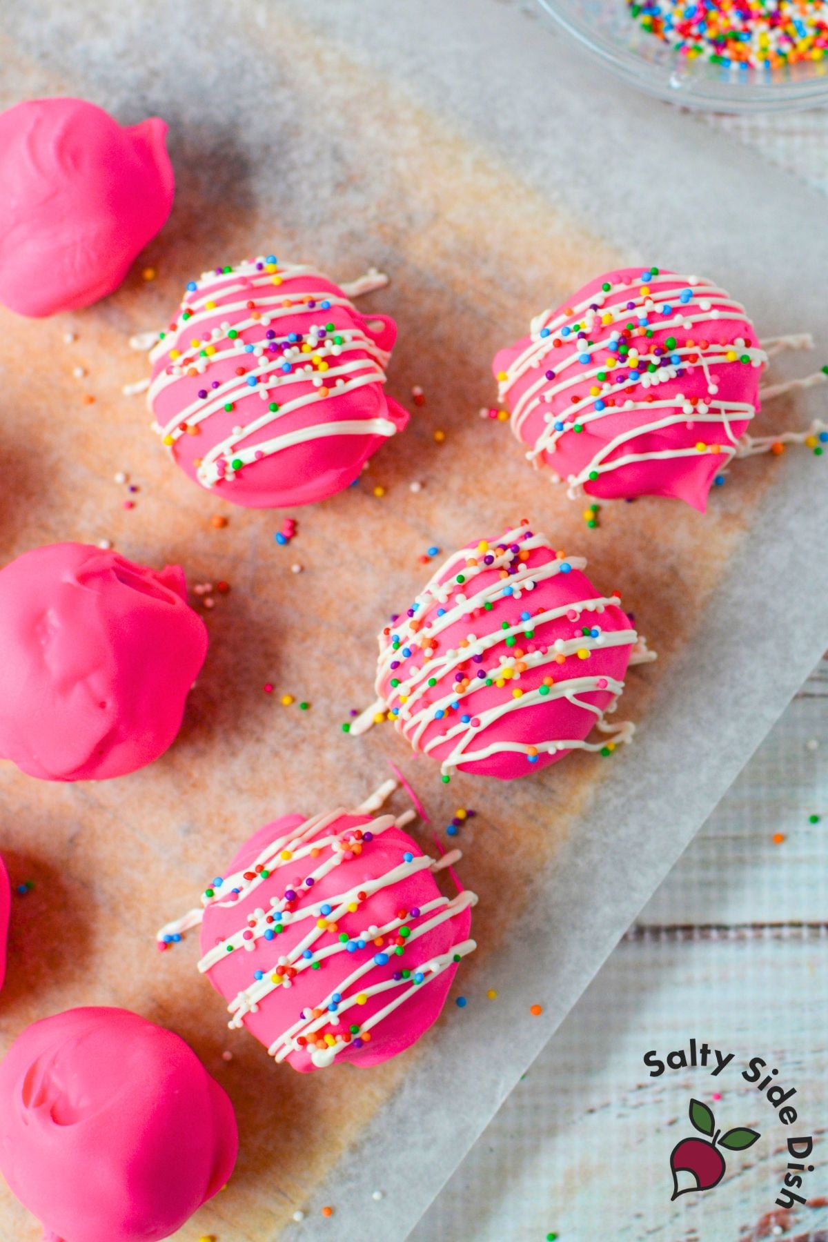 Pink Circus Animal Cookie Truffles drizzled with white candy melts and topped with rainbow sprinkles