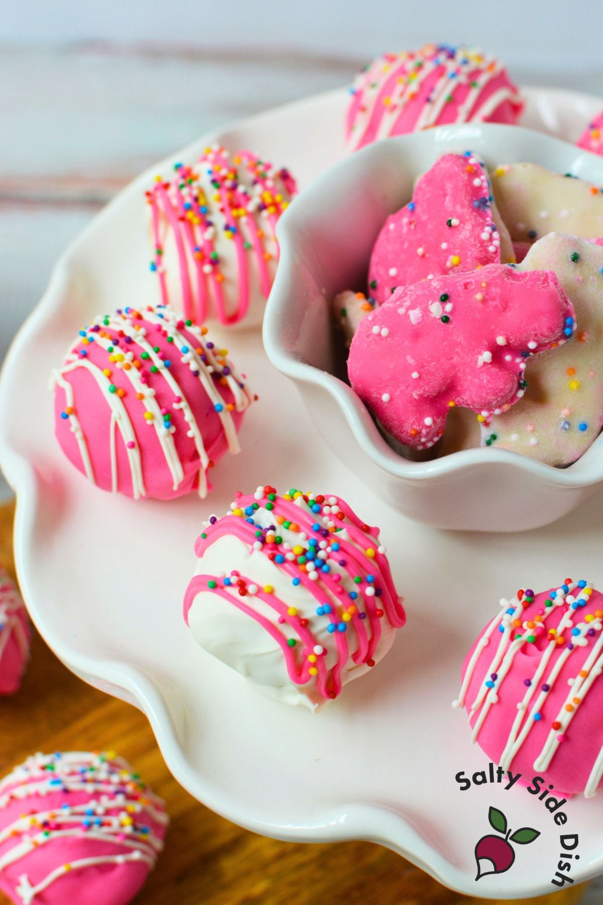 Pink and white Circus Animal Cookie Truffles served with frosted animal cookies