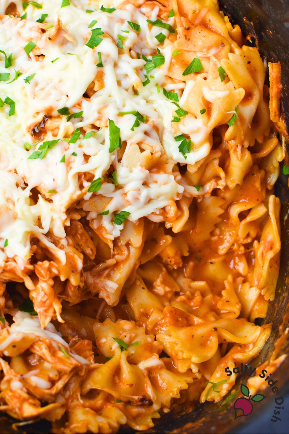 Slow cooker chicken pasta with pink sauce, mozzarella, and parsley
