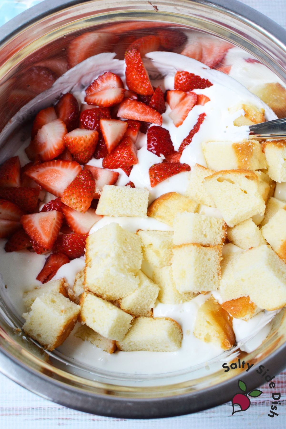 Fresh strawberries and cubed pound cake added to the creamy whipped topping mixture
