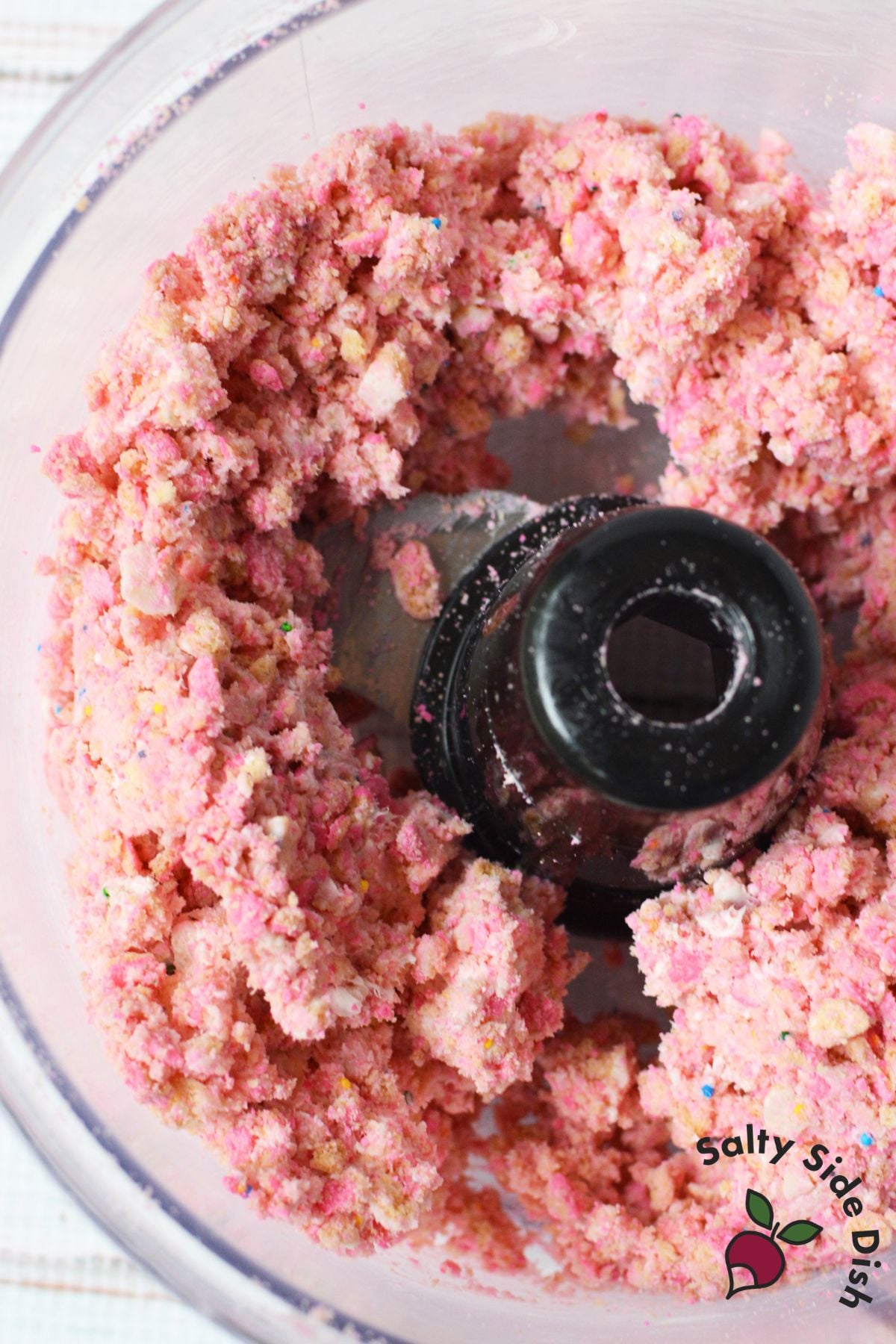 Crushed Circus Animal Cookies mixed with cream cheese in a food processor for truffle filling