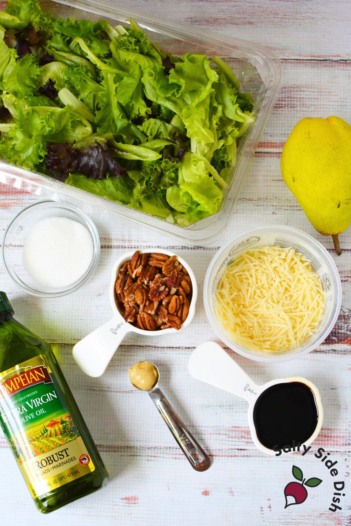 Fall pear salad ingredients with spring mix, pear, pecans, Parmesan, balsamic vinegar, Dijon mustard, sugar, and olive oil