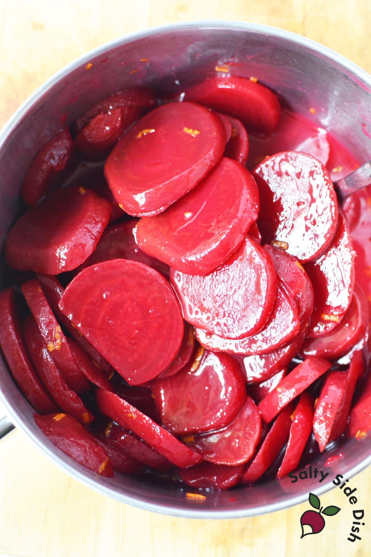 Sliced Harvard beets coated in sweet and tangy sauce in a saucepan