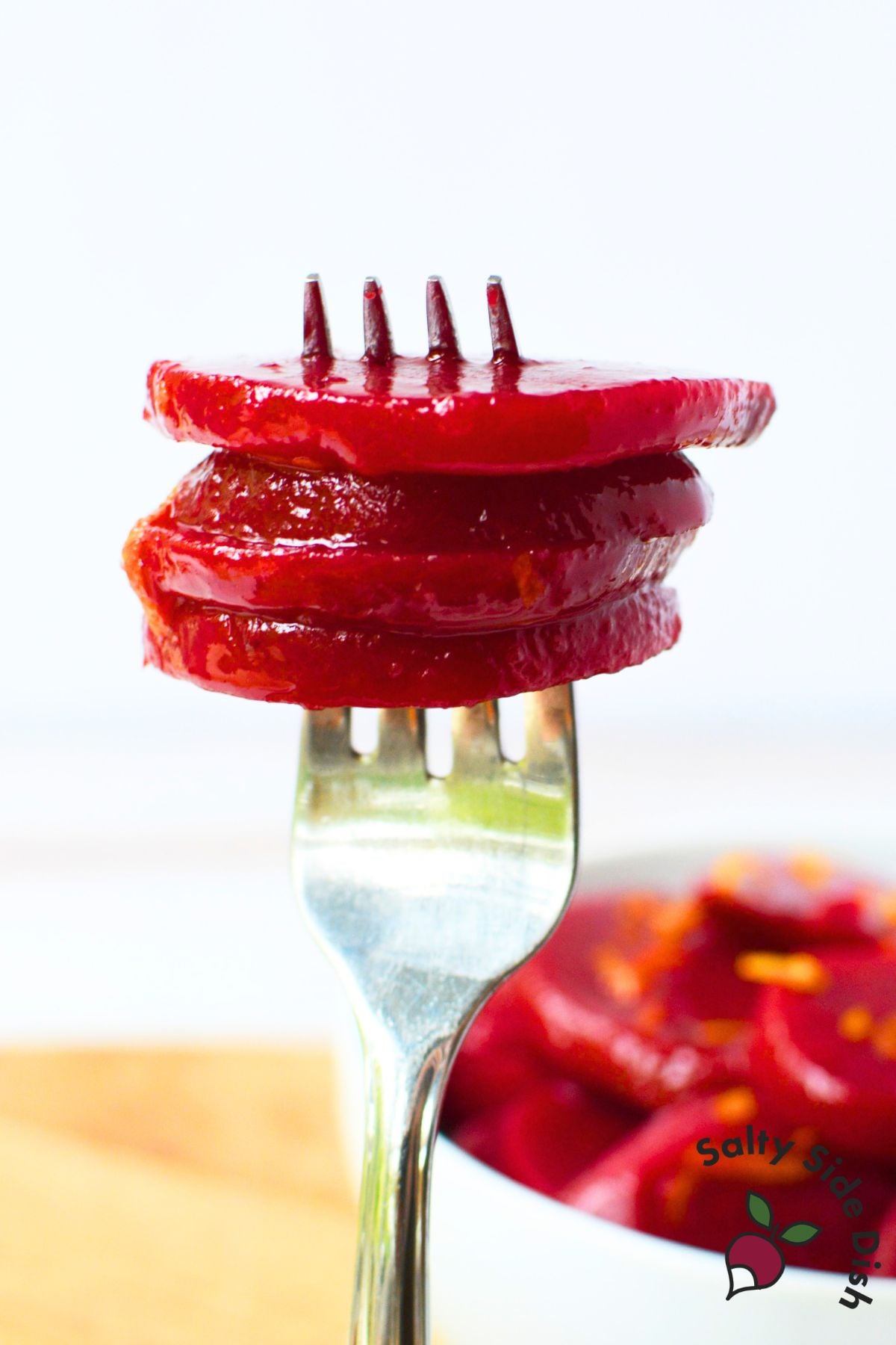 Close-up of sliced Harvard beets stacked on a fork