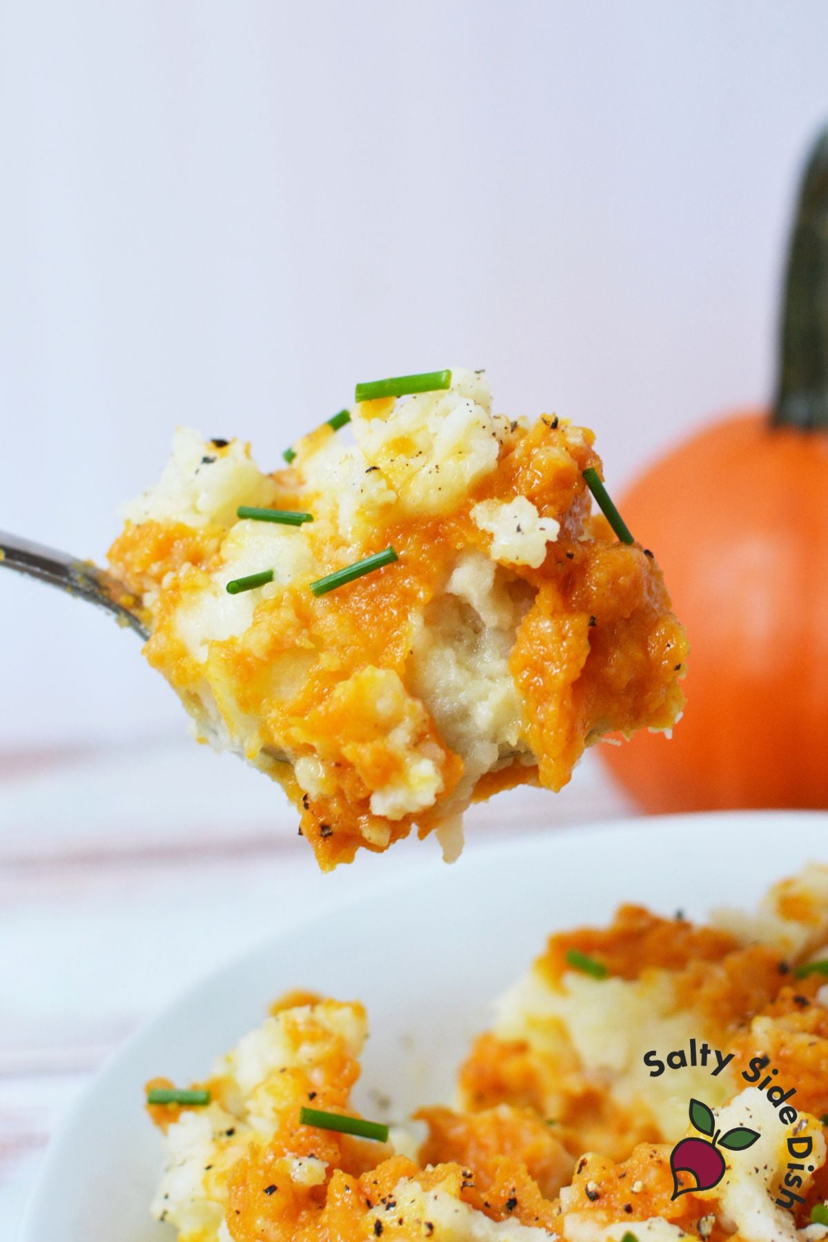 Pumpkin mashed potatoes with savory pumpkin puree, chives, and black pepper