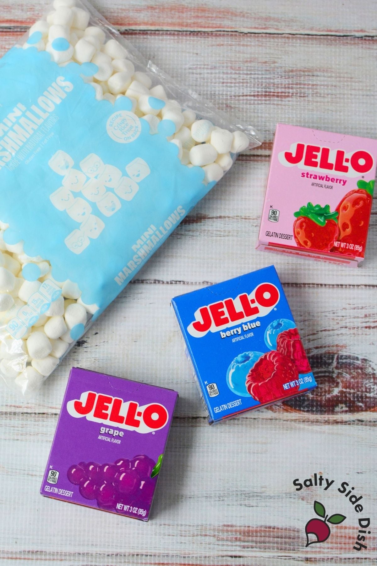 Jello roll ups ingredients with strawberry, berry blue, and grape Jello plus mini marshmallows