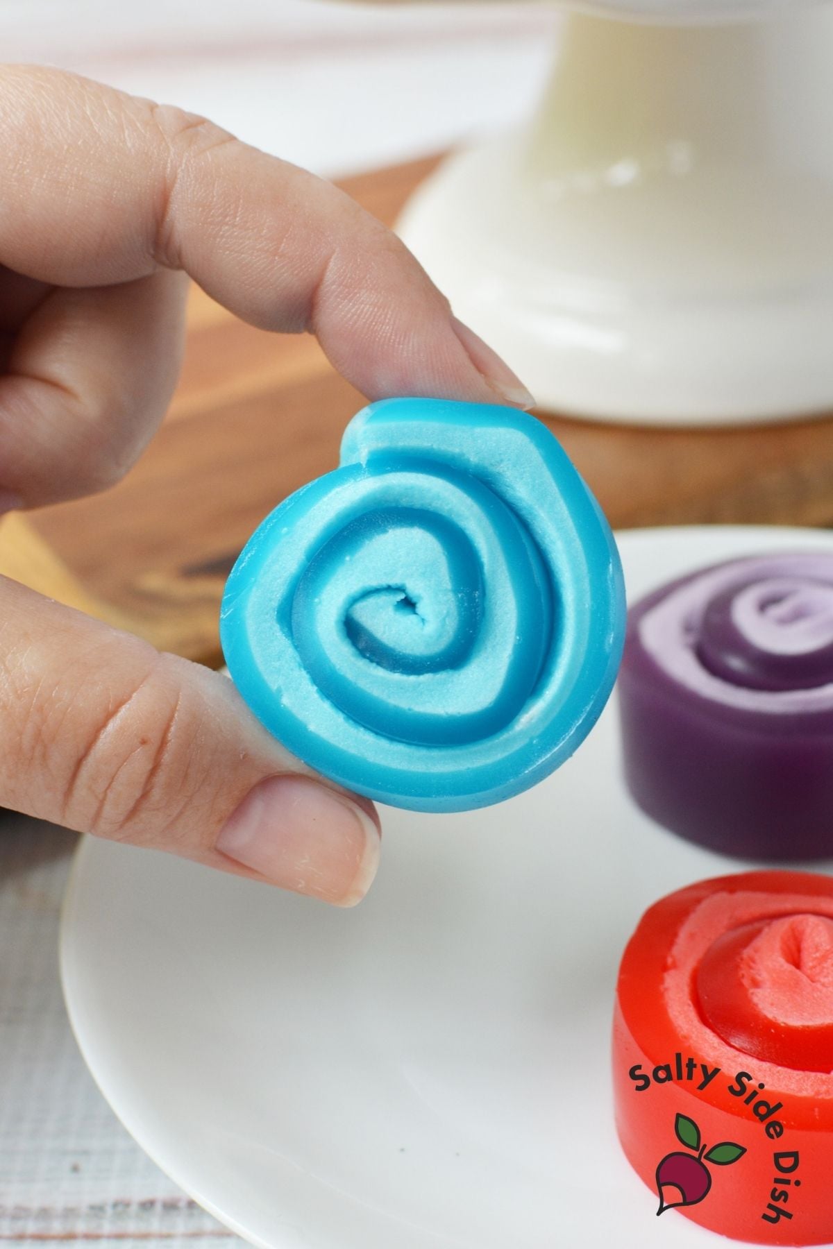 Blue Jello marshmallow roll up showing the two-tone spiral center