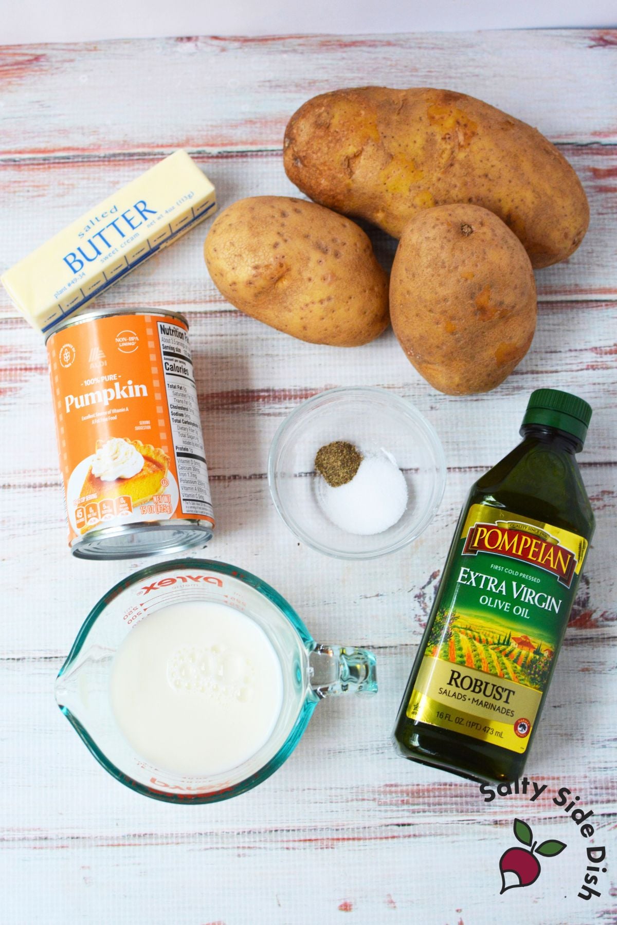 Ingredients for pumpkin mashed potatoes with russet potatoes, pumpkin puree, butter, milk, olive oil, salt, and pepper